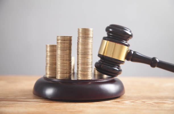 istock Stack of coins with judge gavel. 1248887556