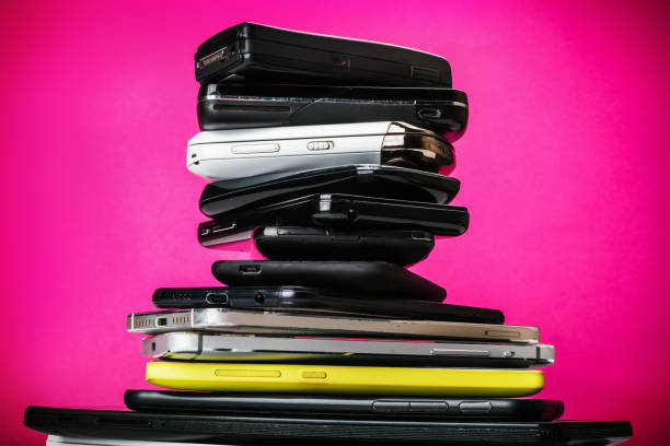 istock dirty, broken and old smartphones on a pink background 1248891734