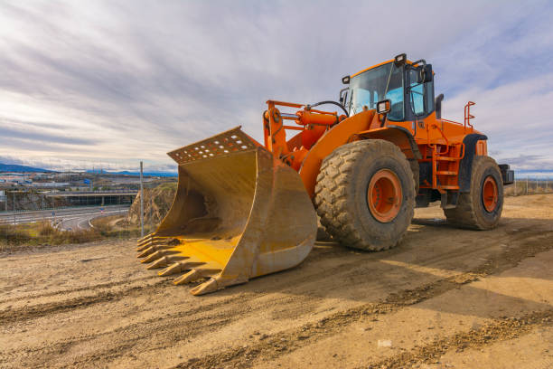 istock Excavator moving earth on a road construction works 1248892537