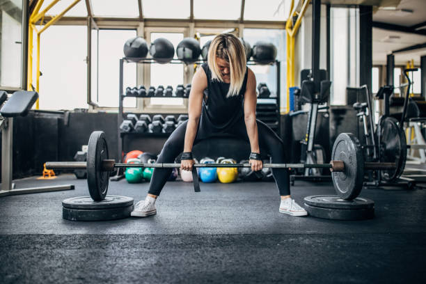 istock Fit young woman weightlifting 1248894465