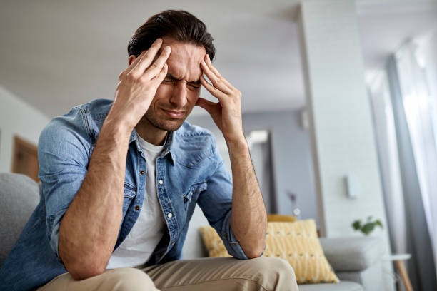 istock Below view of a man having a headache while being at home. 1248896850