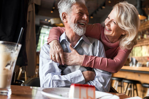 istock Wife feeding husband with a slice of cake 1248897275