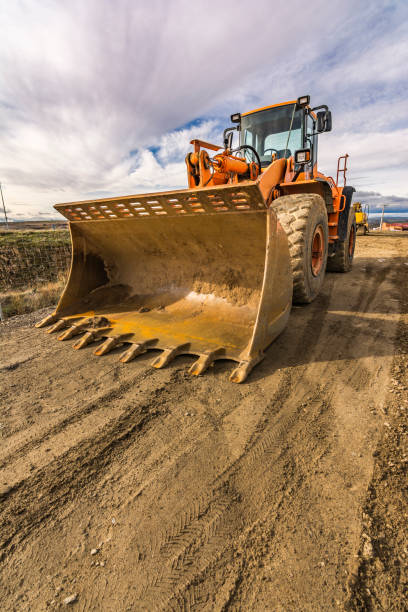 istock Excavator moving earth on a road construction works 1248897397