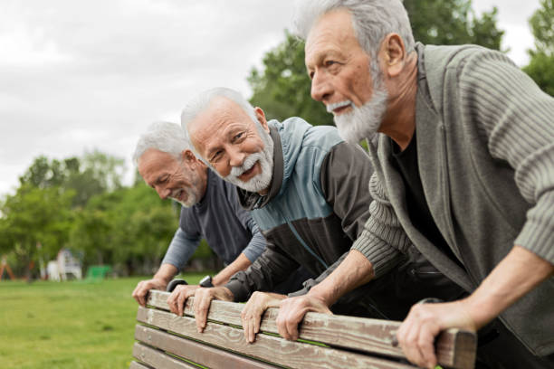 istock Three men exercising together in public park 1248897570