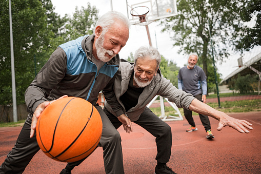 Active senior friends on basketball court