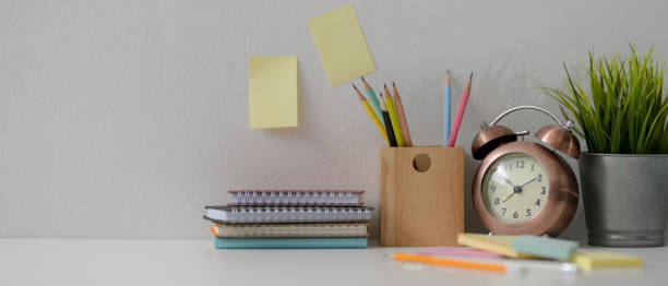 istock Home office desk with diary notebooks, stationery, decorations and copy space on white desk 1248898844