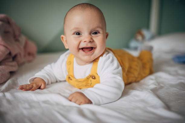istock One happy cute baby boy lying on bed 1248899159