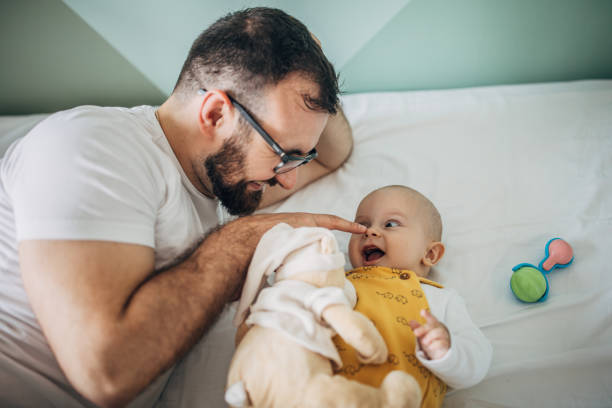 istock Father playing with his baby boy on bed 1248899906
