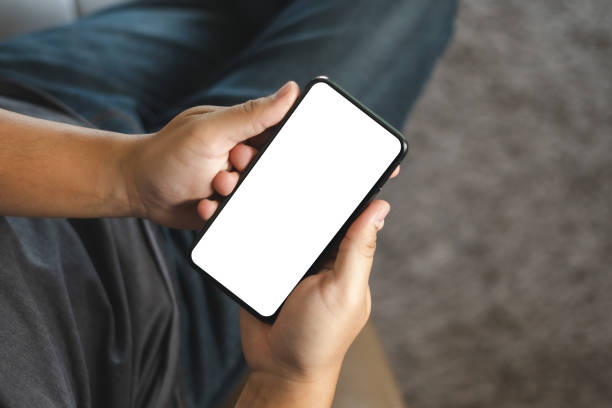 istock Top view Mockup image hand using a smartphone man Holding Cell Phone With Blank Screen 1248900039
