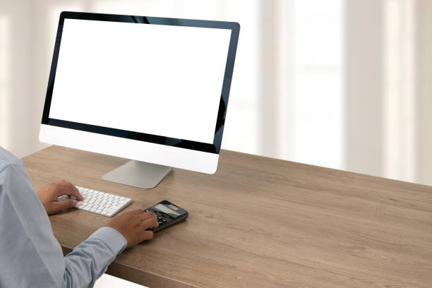 istock young man working Businessman using a desktop computer of the blank screen 1248900081
