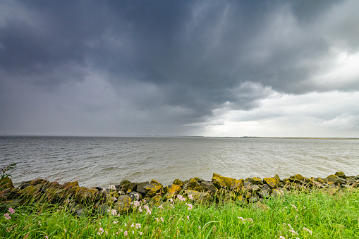 Storm clouds over the Ketelmeer lake during springtime in Flevoland, The Netherlands