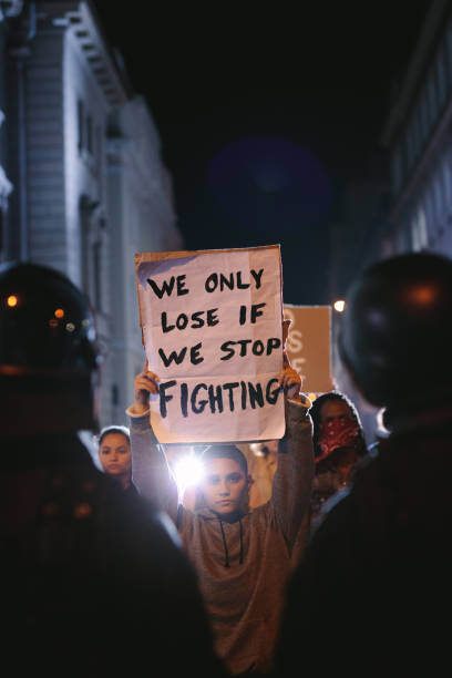 istock Group of demonstrators in front of police force 1248902824
