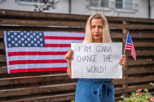 istock Young woman holding a poster with anti-racist message 1248903386