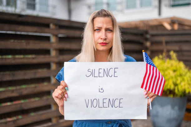 istock Young woman holding a poster with anti-racist message 1248903390