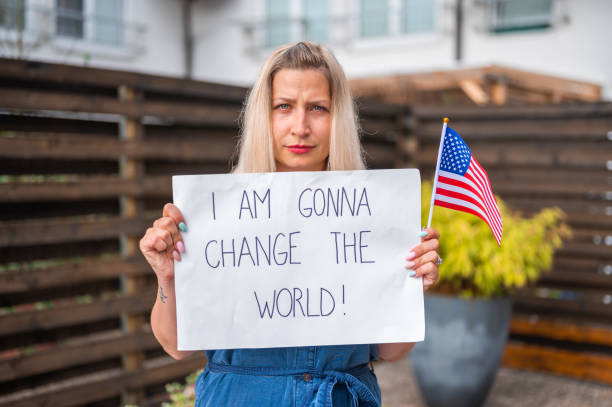 istock Young woman holding a poster with anti-racist message 1248904494