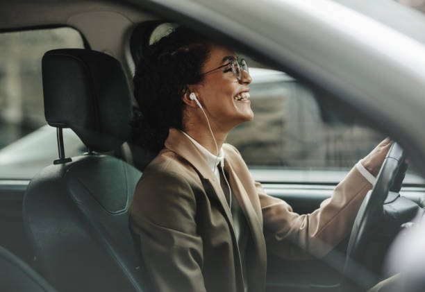 istock Businesswoman enjoying music while driving to work 1248905592