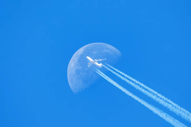 Passenger plane - airliner passes near the moon. Explore new frontier. Space traveler concept