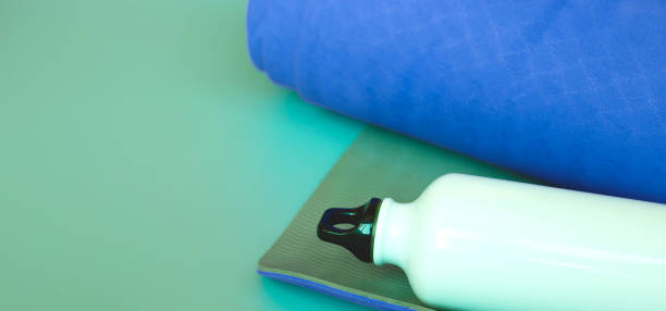 istock Bright blue yoga mat on a gray background. 1248907576