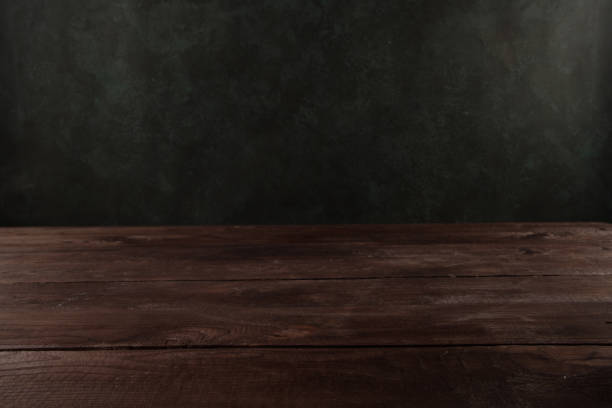 istock Image of wooden table in front of blurred background. Empty wooden table platform over background for present product. 1248907698