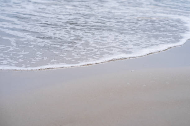 Soft wave of the sea on the sand beach stock photo