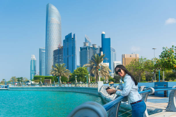 istock Asian tourist visiting Abu Dhabi downtown corniche area and enjoying the view 1248913150