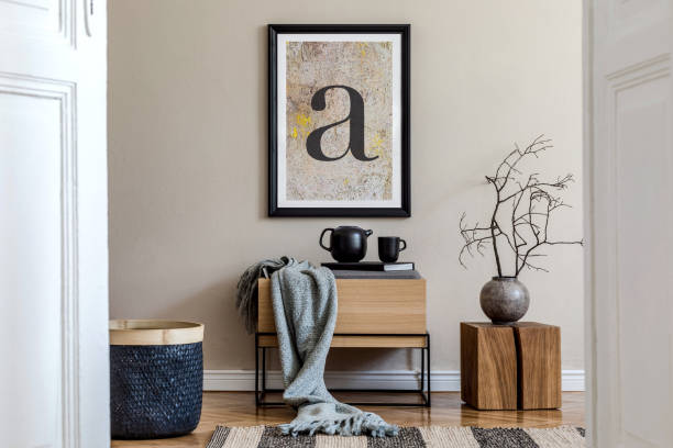 istock Modern scandinavian living room interior with black mock up poster frame, design commode, dried flower in vase, black rattan basket, books and elegant accessories. Template. 1248913817