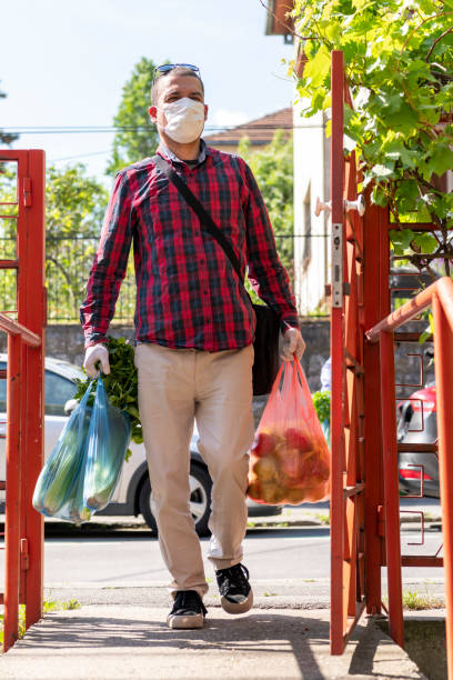istock Mature Man is Delivering Groceries During a Pandemic Time. 1248917320