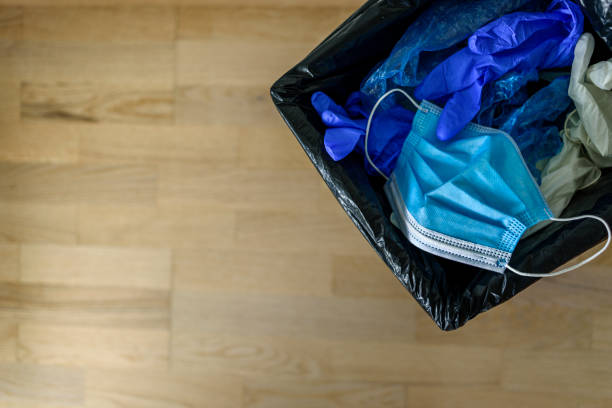 istock Waste container with medical garbage - face mask, gloves in corridor 1248919173