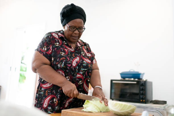 istock Grandmother chopping cabbage in the kitchen 1248927369