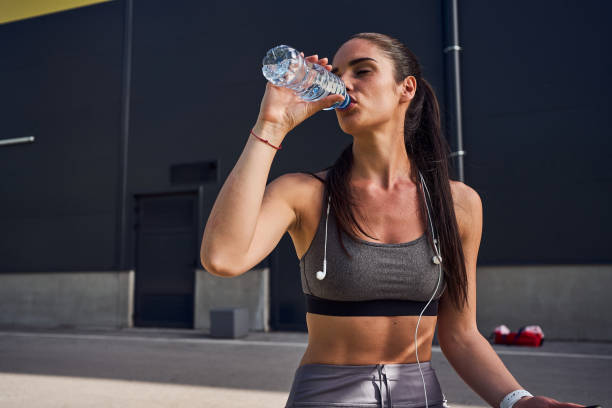 istock Dehydrated female runner drinking a water so she can refresh for another round of running 1248929206