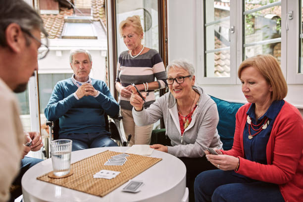 istock Cheerful nursing home users playing card game and having so much fun 1248930354