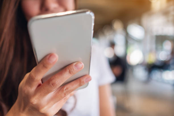 istock a woman holding , using and looking at mobile phone 1248932432