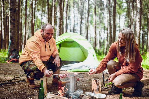 istock Camping Couple Making Skewer Barbecue 1248932454
