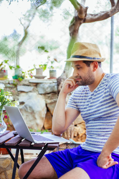 istock Man checking his e-mail at outside wearing protection mask during covid-19 1248932524