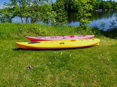 Two Kyaks on the shore of a freshwater lake