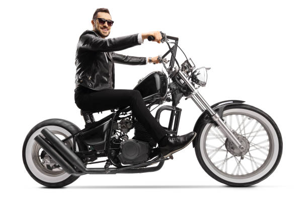 istock Handsome man biker on a custom chopper 1248935380