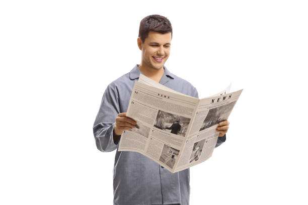 istock Man in pyjamas standing and reading a newspaper 1248936324