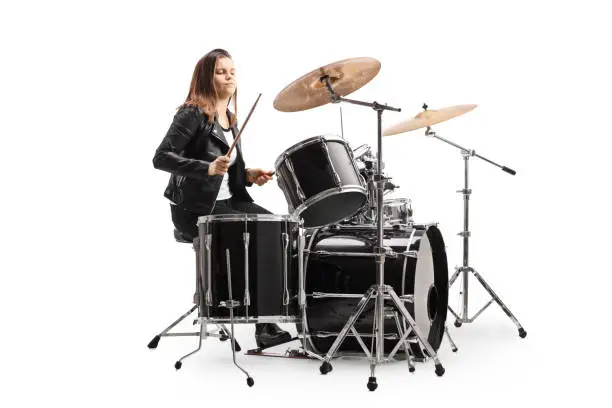 Photo of Young female musician playing a drum kit