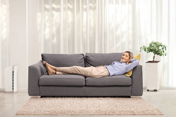istock Young woman resting on a sofa at home 1248937483