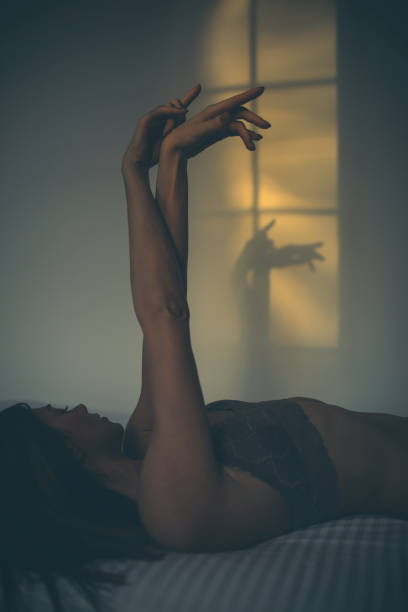 istock Beautiful girl playing with her shadow on the wall 1248939050