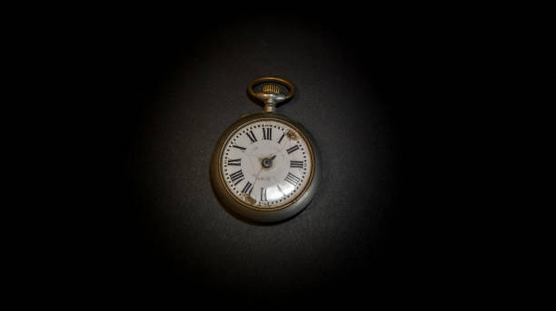istock Deteriorated old pocket watch on black background 1248939212
