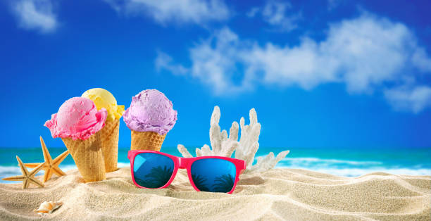 istock Ice creams cones and seashells in the sand on the beach 1248939735