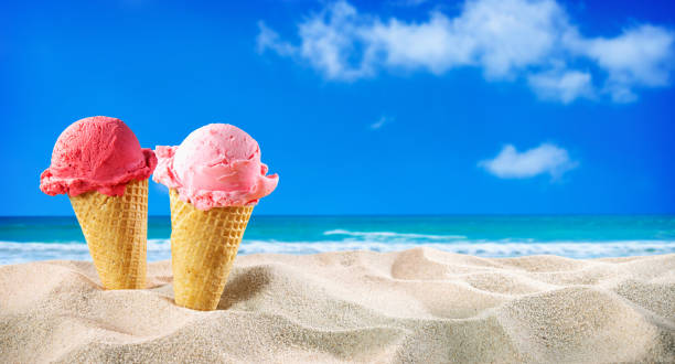 istock Ice creams cones and seashells in the sand on the beach 1248939739