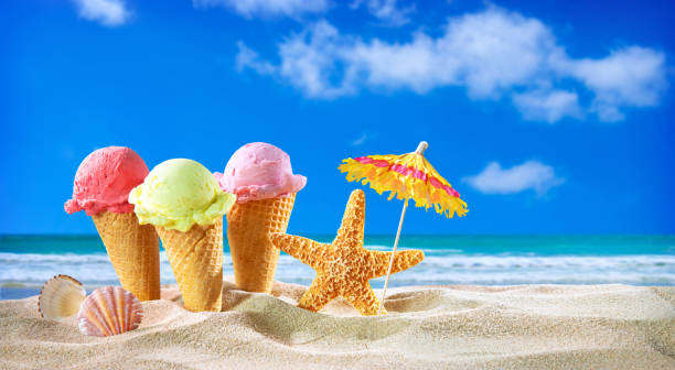 istock Ice creams cones and seashells in the sand on the beach 1248939763