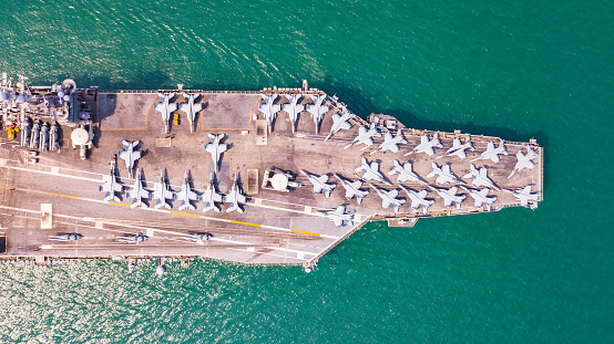 American aircraft carrier anchored in a harbour after offshore training exercises.