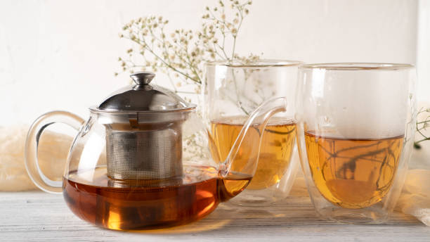 istock Morning romantic tea for couples. Black tea in regular glass teapot. Hot tea in double wall cups. Double walled mugs. 1248941249
