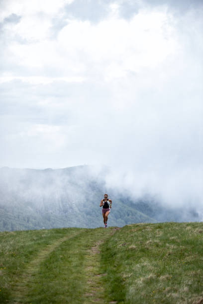 istock Young woman running on mountain 1248941447