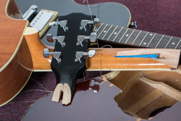 istock Smashed guitars. Pile of broken electric and acoustic guitar bits. 1248945201