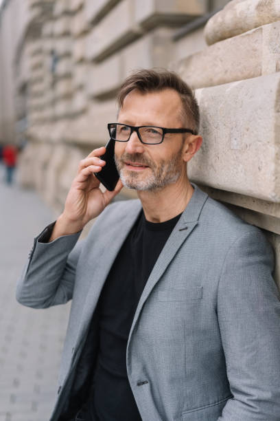 istock Mature metro man talking on phone in urban scene 1248948285