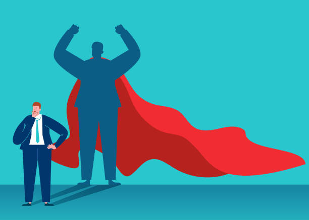 istock Businessman imagines himself becoming a superhero wearing a cape 1248948370